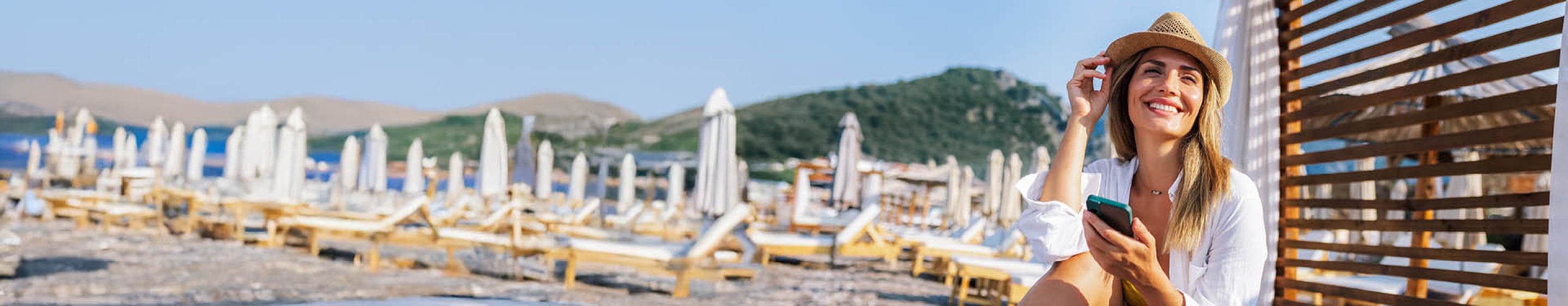 Woman relaxing on beach with phone